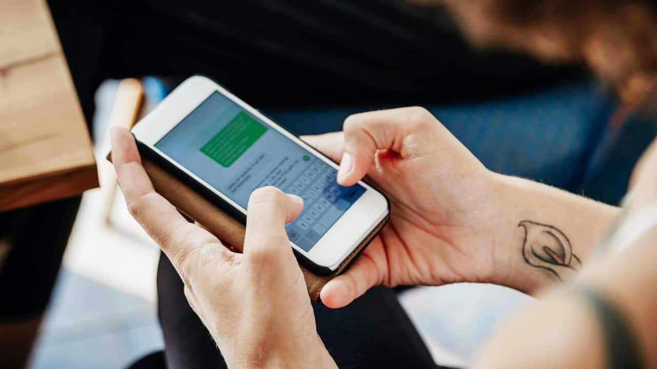 Close Up Of Woman Messaging Friends Using Smartphone