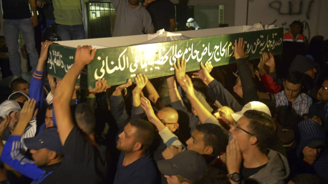 Mourners carry the body of Abdelrahman Shaludi