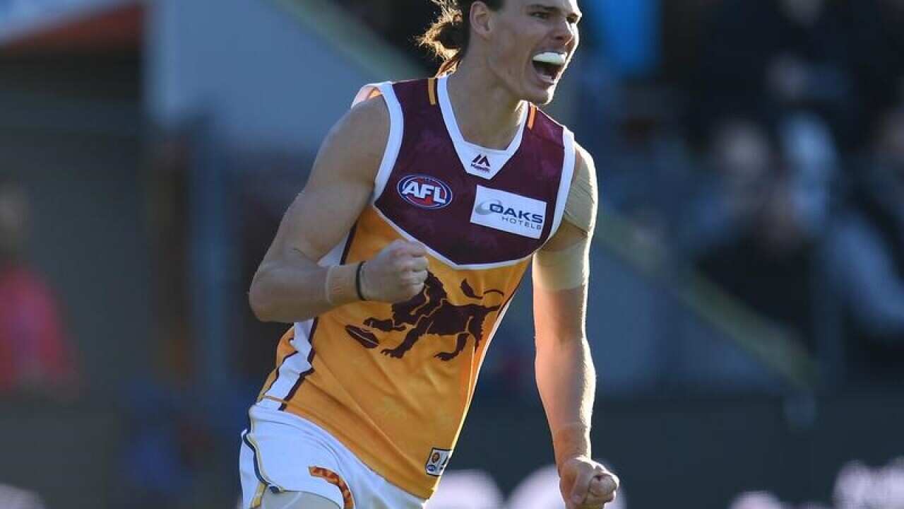 Eric Hipwood of the Lions celebrates kicking a goal against the Hawks.