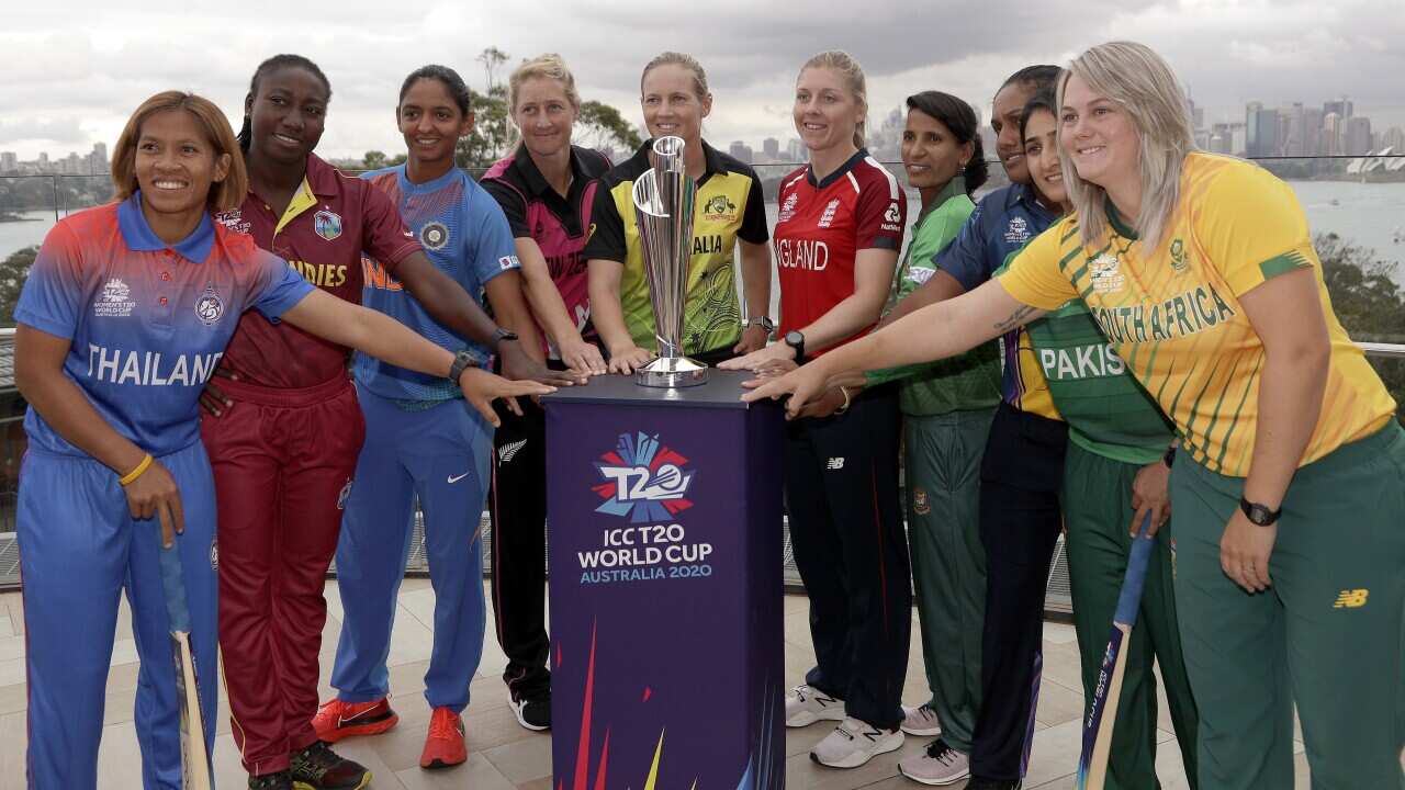 The captains of the 10 countries participating in the Women's T20 World Cup pose with the trophy in Sydney.