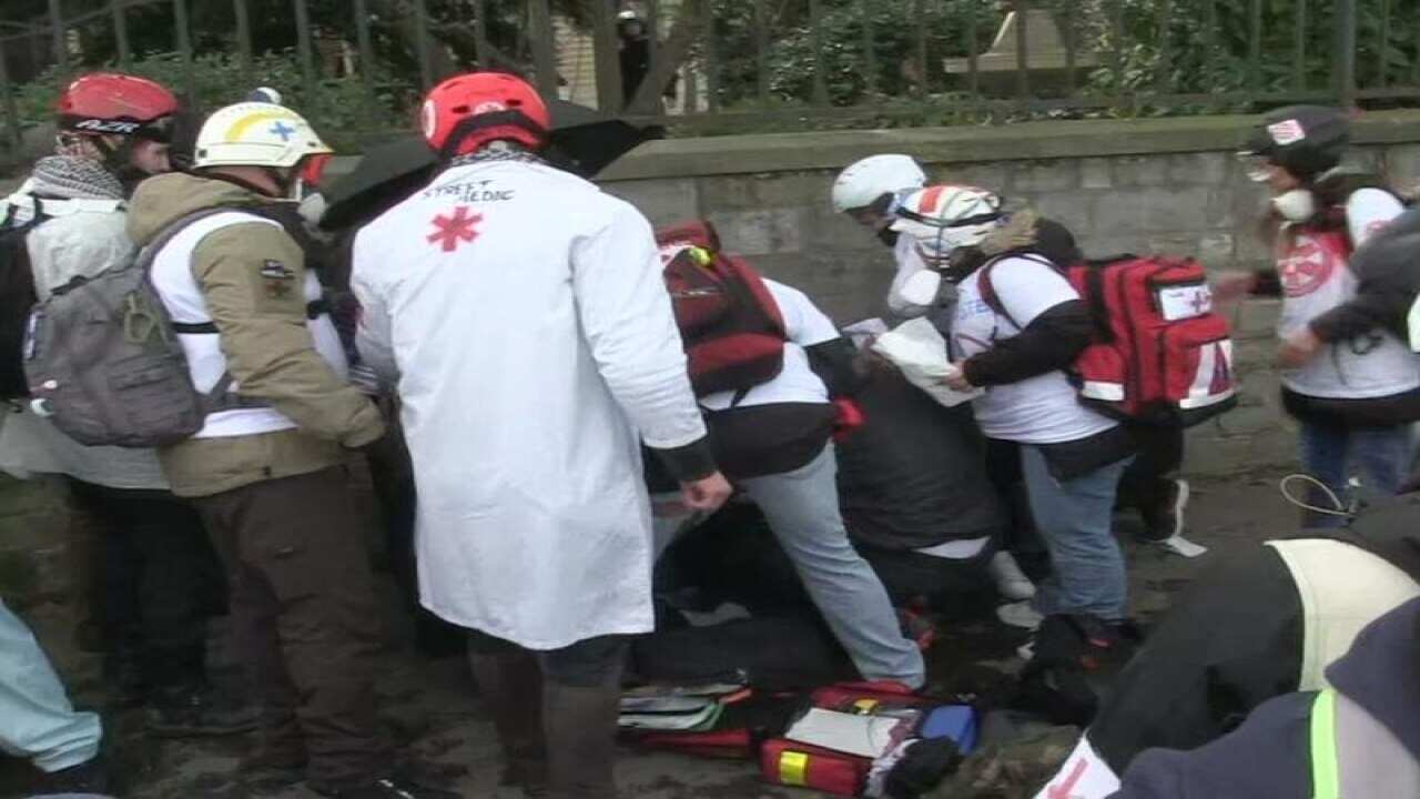 Emergency services attend to the protester who injured his hand