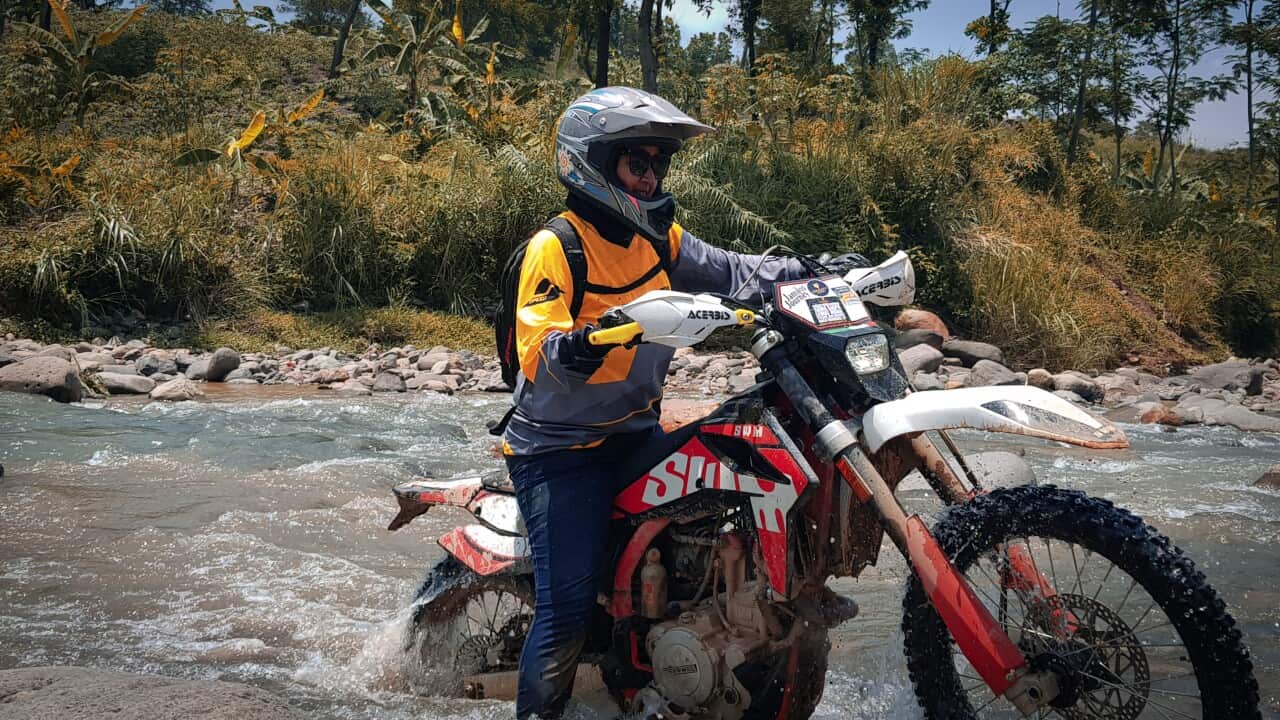 Johana Krisna Murti - through the water on a trailbike.