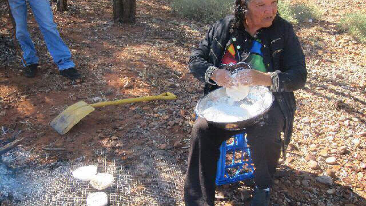 Indigenous Elder Nana Joan preparing bush tucker