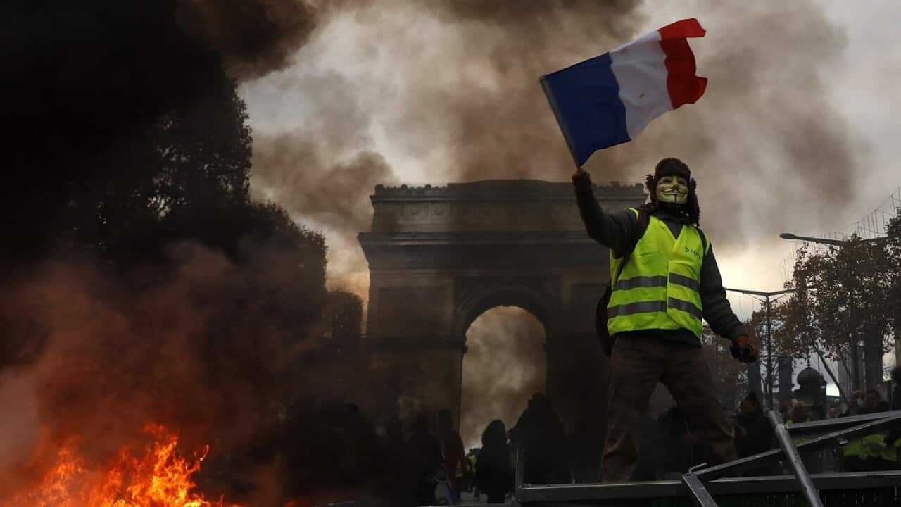 Yellow vests (Gilets jaunes) protest against rising oil prices and living costs near the Arc de Triomphe on the Champs Elysees in Paris.