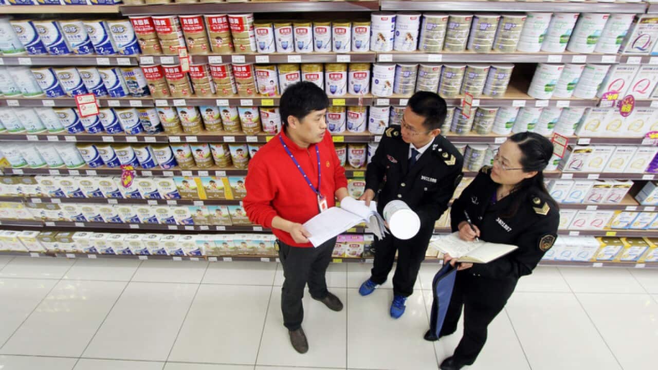 Chinese officials inspect baby formula for sale at a supermarket in Hefei City (File photo)