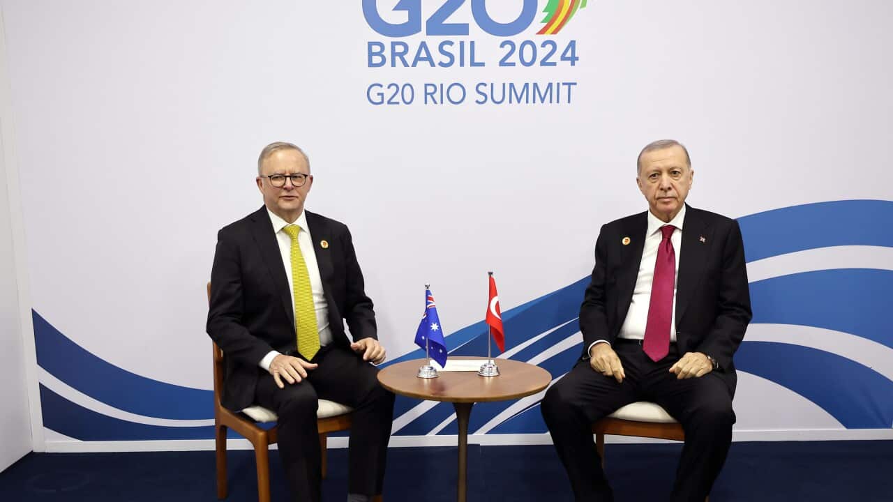 Australian Prime Minister Anthony Albanese and Turkish President Recep Tayyip Erdogan sitting beside each other at a small round table. The Australian and Tyrkish