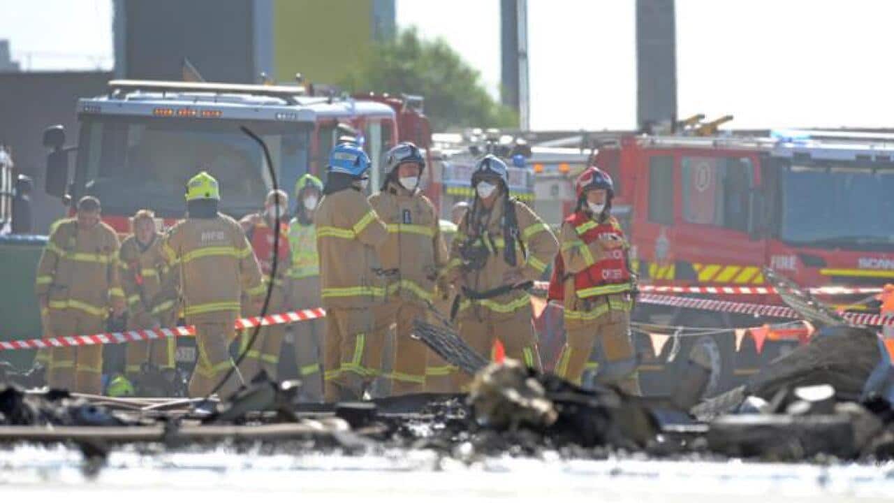 Fire crew at the scene where a light plane crashed into the back of a DFO building at Essendon airport in Melbourne, Tuesday 21, 2017. (AAP Image/Joe Castro) NO ARCHIVING, EDITORIAL USE ONLY