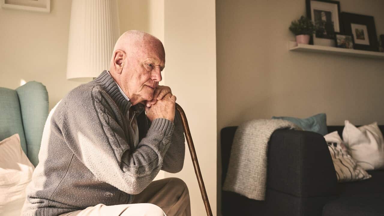 Elderly man sitting alone at home