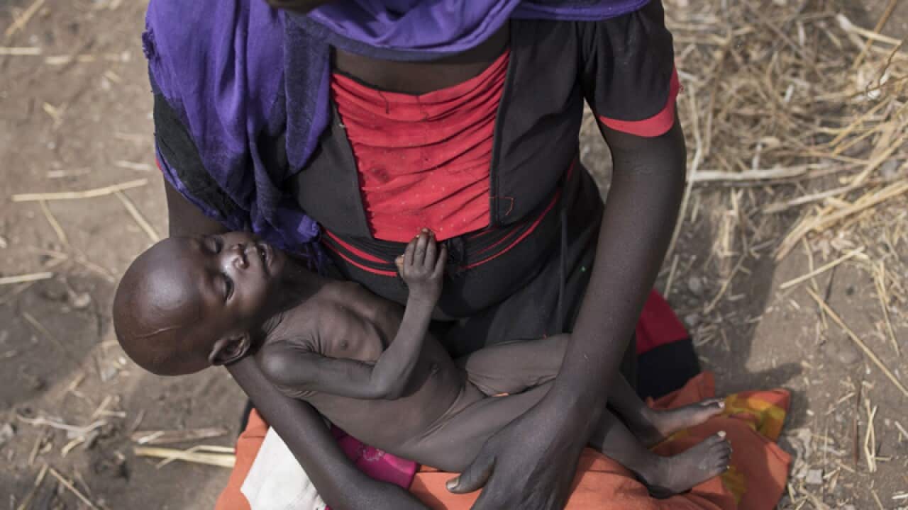 A mother cradles her 10-month-old daughter