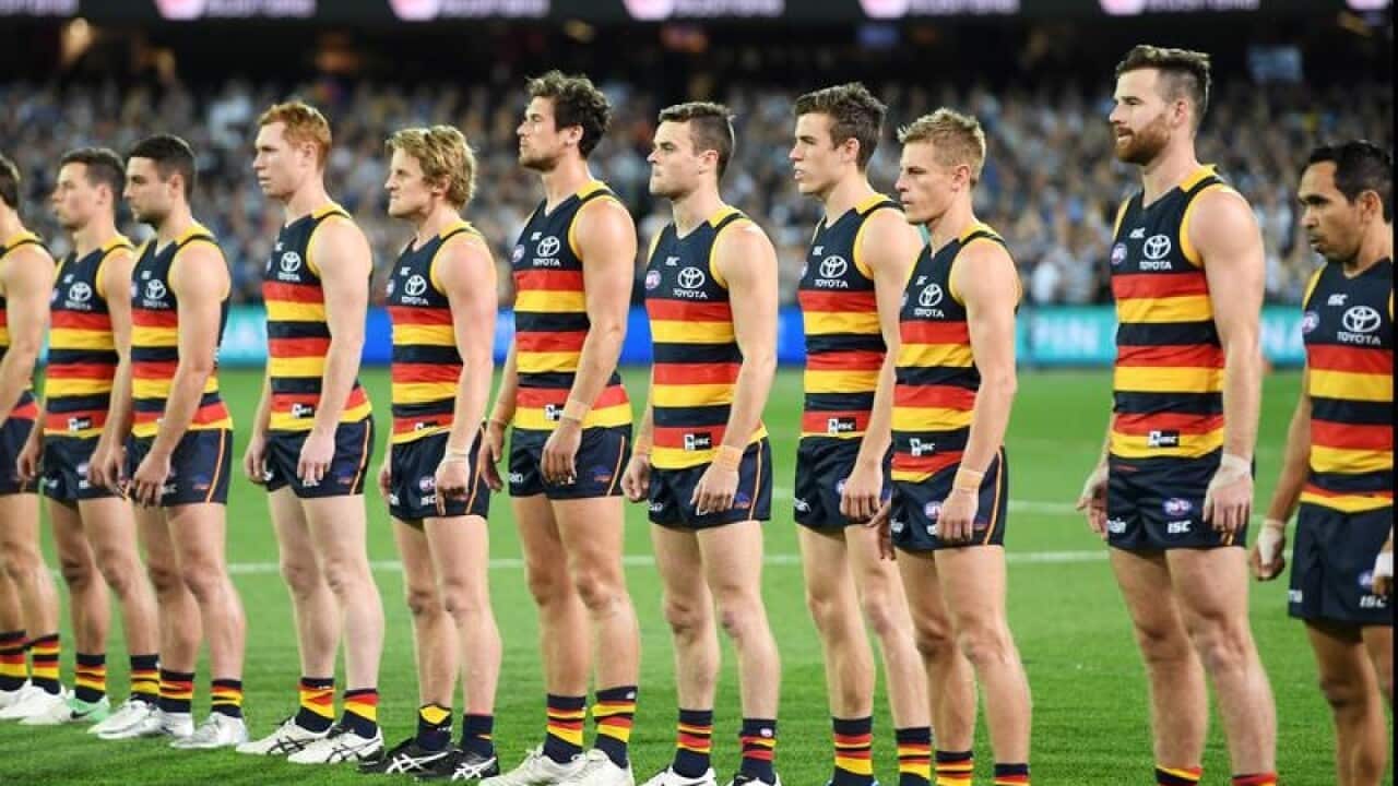 The Adelaide Crows line up for the national anthem.