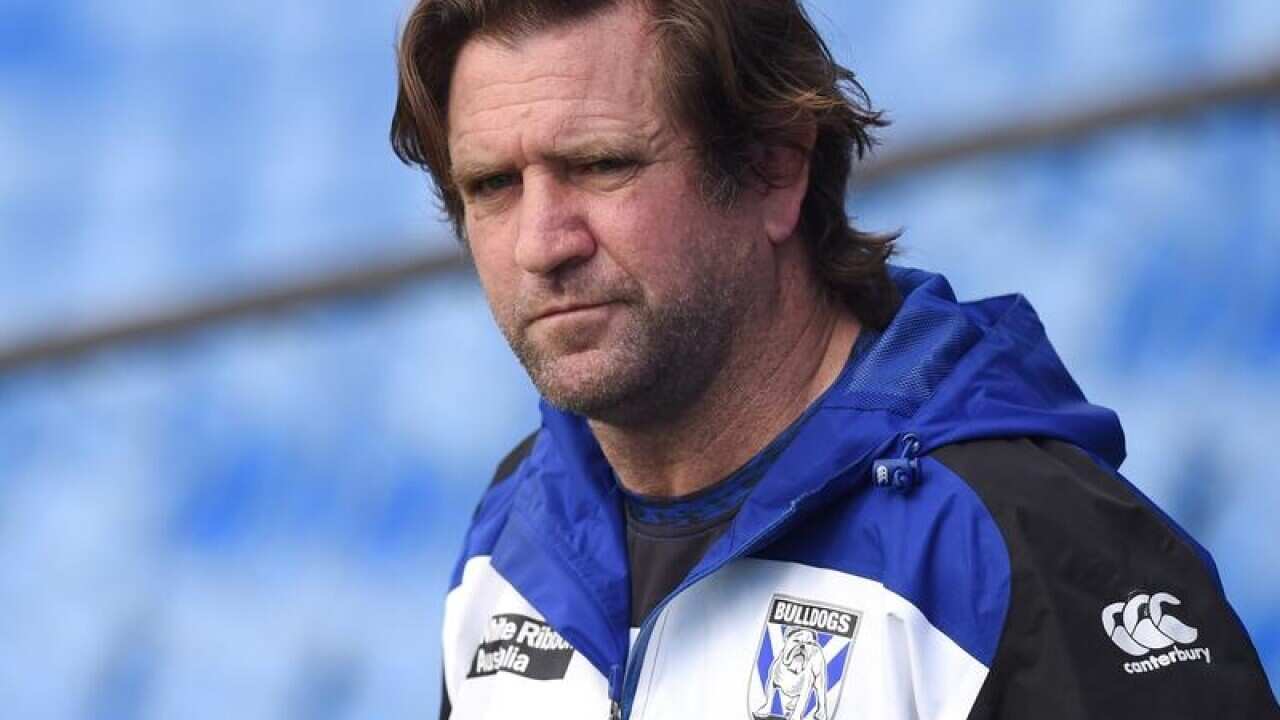 NRL coach Des Hasler looks on.