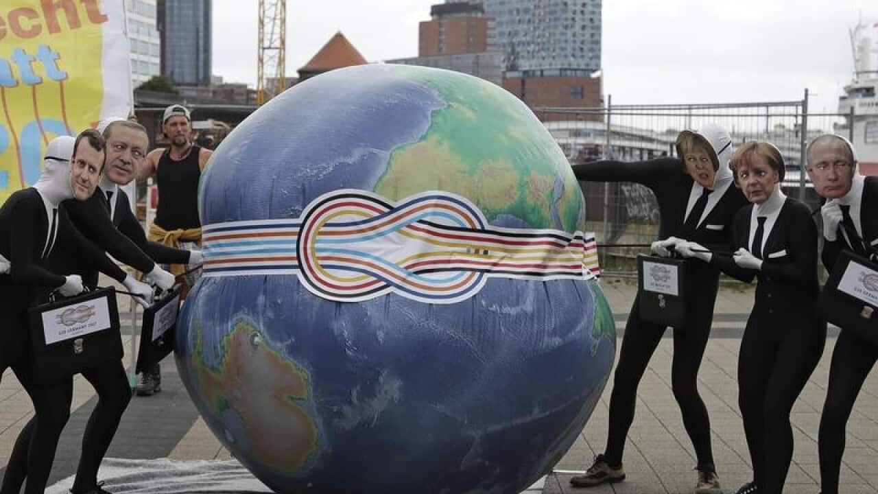 Activists perform in a demonstration before the G20 summit in Hamburg