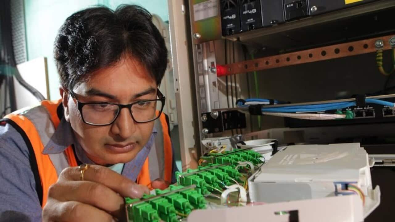 NBN technician Rajav Kapil connecting an apartment block to the National Broadband Network (NBN) in Brunswick, Melbourne, Tuesday, March 11, 2014. (AAP Image/David Crosling) NO ARCHIVING