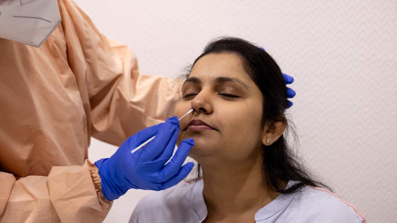 Woman undergoing a coronavirus test via her nose