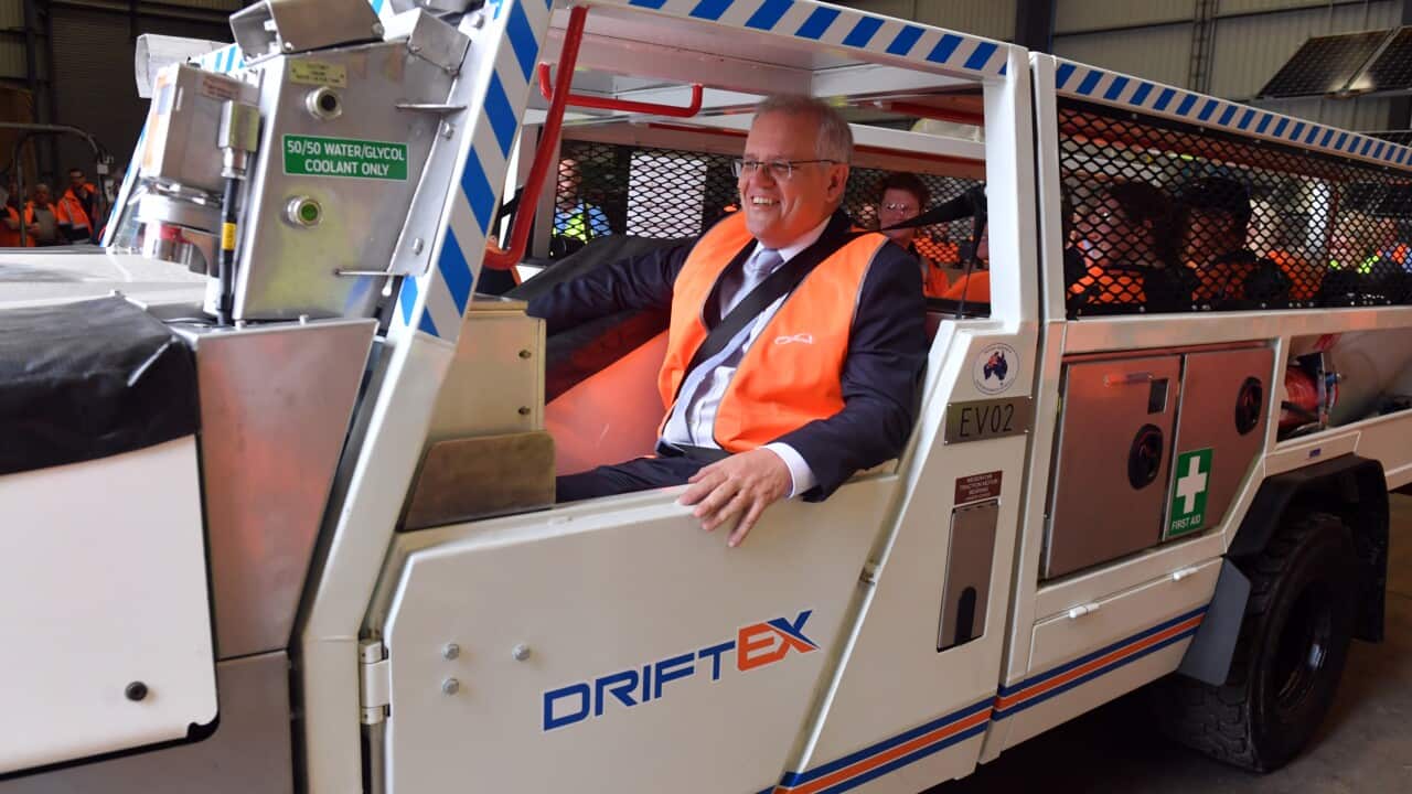 Prime Minister Scott Morrison inside an electric vehicle at an engineering facility specialising in renewable technology during a visit to the Hunter Valley.