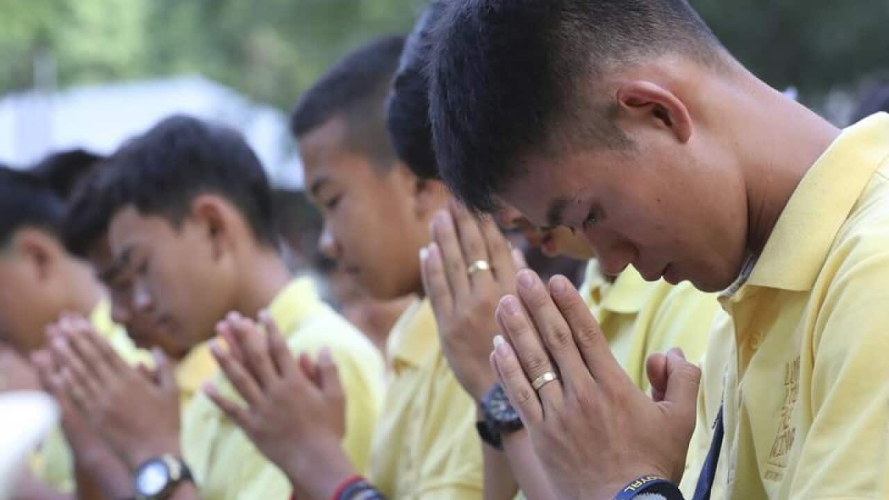 Wild Boars soccer team in Buddhist prayers.