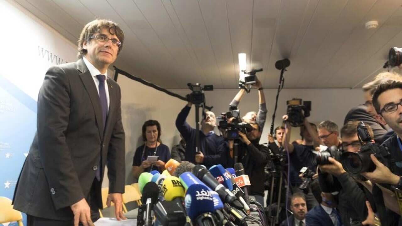 Carles Puigdemont looks on after a press conference.