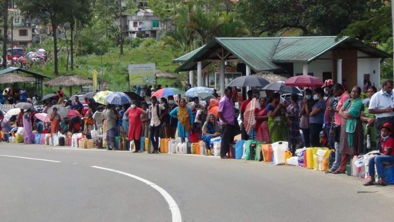 People standing in queues for essentials