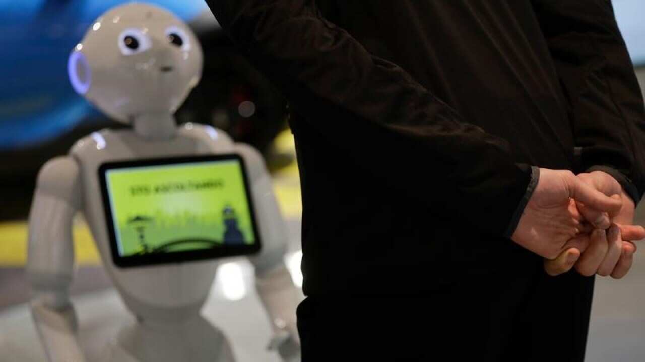 A guests asks a hotel assistance robot for information