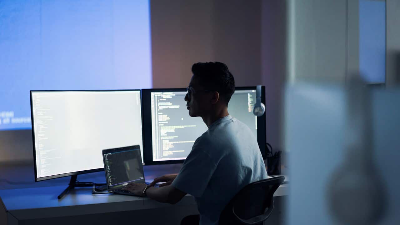 Web design, coding and Asian man with a computer for programming a website at night. Cyber security, developer and programmer reading information for a software database on a pc in a dark office