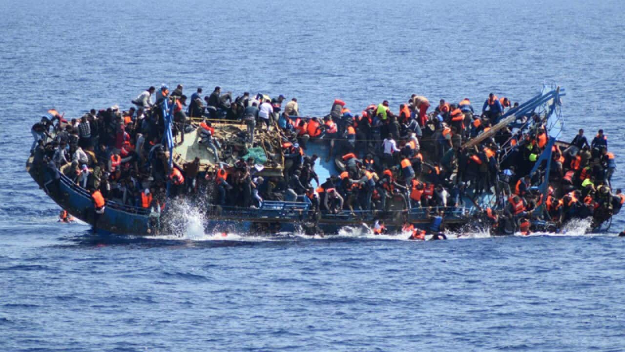 People jump out of a boat right before it overturns