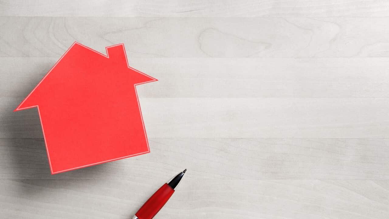 Real estate business. House for sale. Cottage made from cardboard paper on wooden table. House warming party template. Selling and buying home. Empty blank negative copy space.