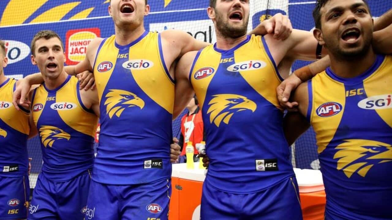 Eagles players celebrate after winning Second AFL qualifying final.