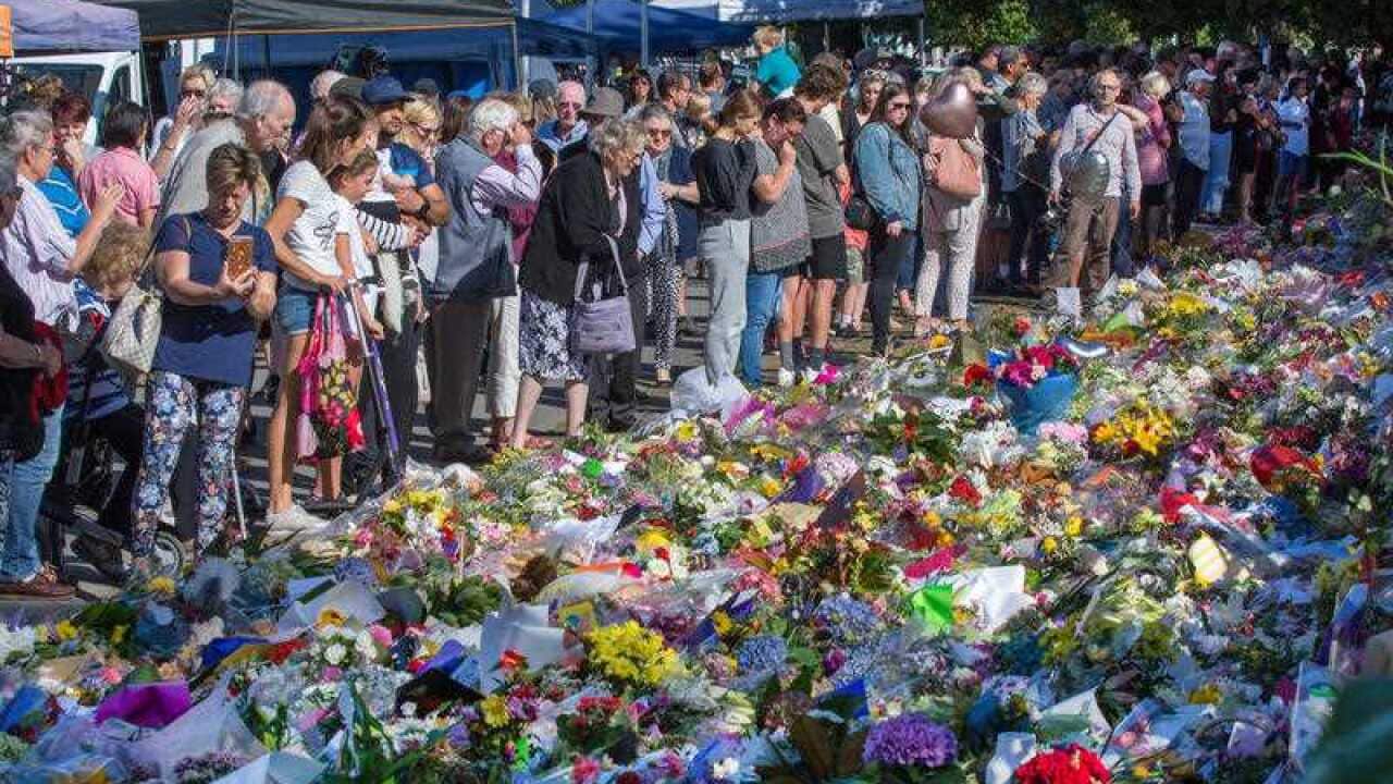 Members of the public look at a makeshift memorial along Rolleston Avenue in Christchurch on Tuesday.