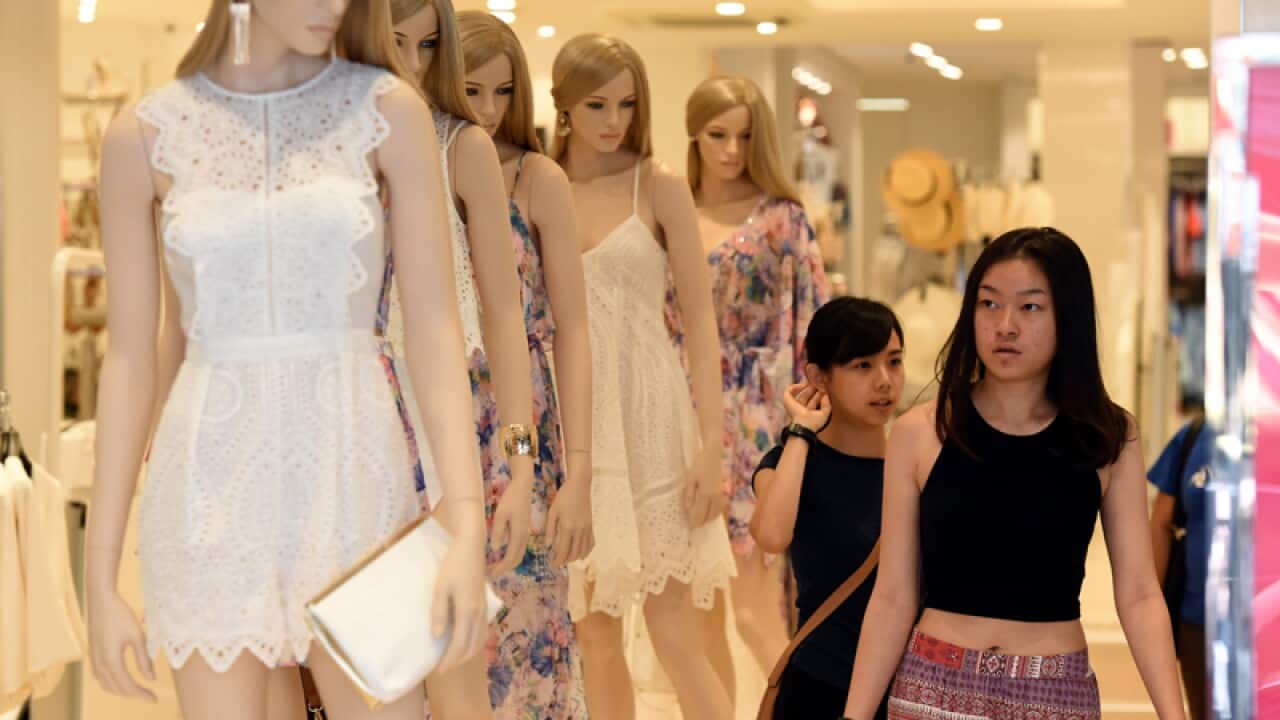 Shoppers inspect merchandise for sale in Queen Street mall in Brisbane