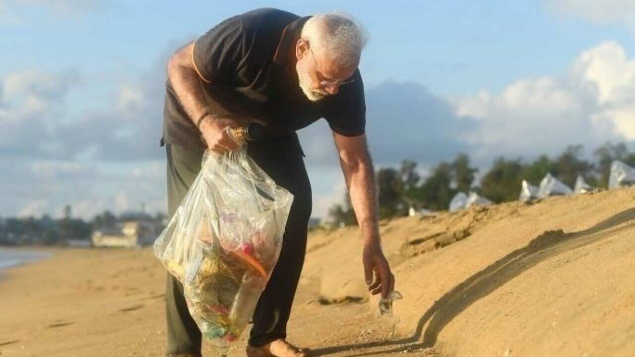 PM Narendra Modi cleaning the beach at Mamallapuram