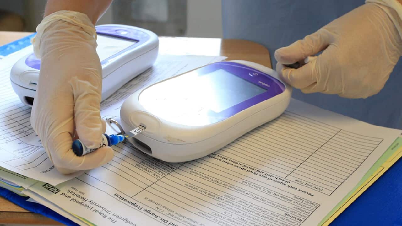 File photo of a nurse giving a patient a diabetes test