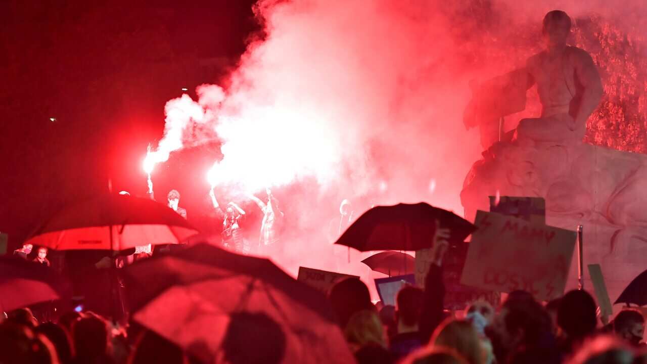 Protesters block a street during a protest against the tightening of the abortion law in Wroclaw, Poland, 26 October 2020.