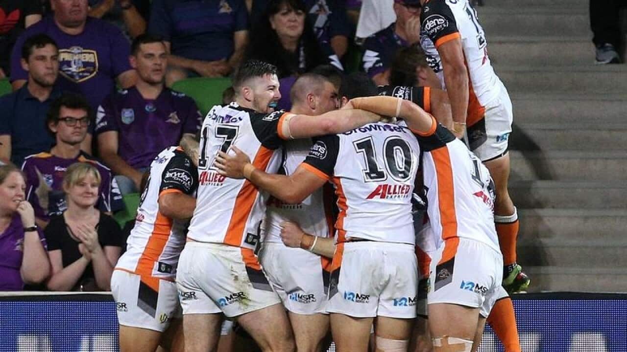 The Tigers celebrate a late try.