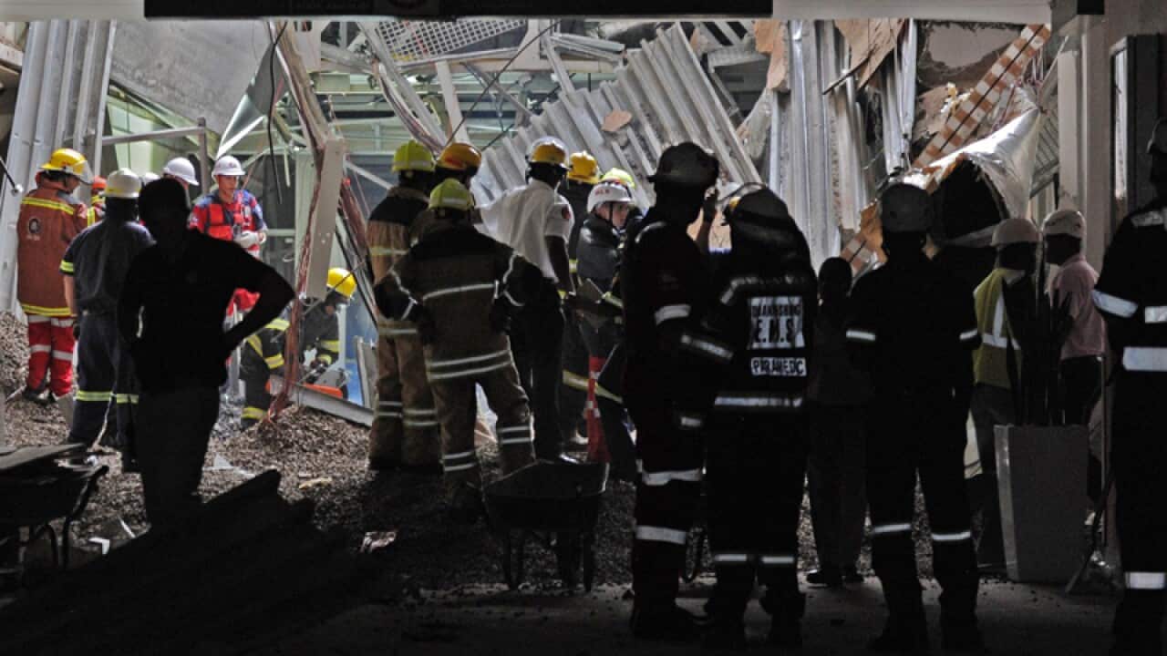 Emergency workers dig through rubble at a hospital in Johannesburg