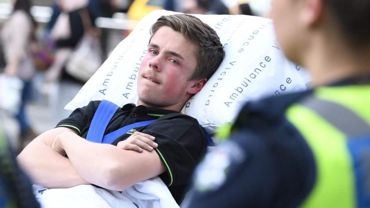 A window cleaner is placed in an ambulance in Melbourne