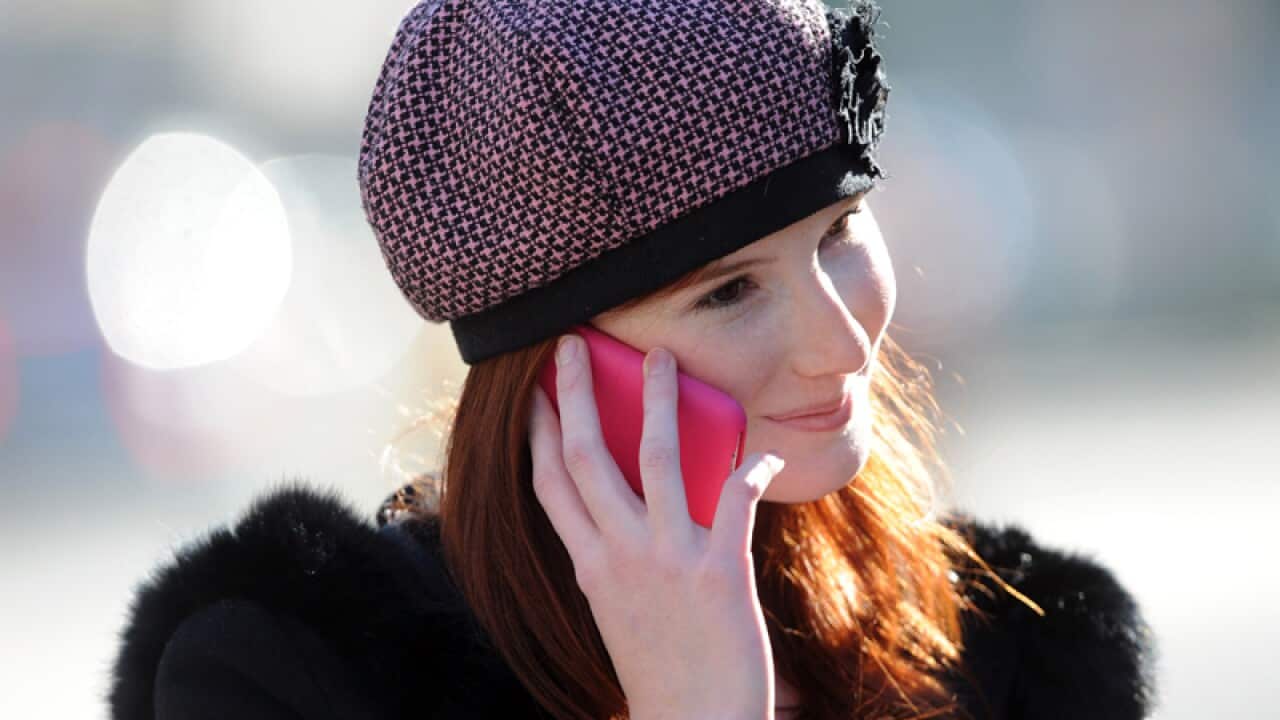 A woman uses a mobile phone