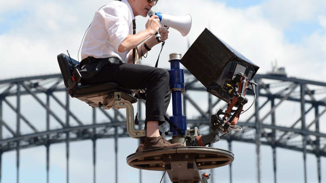 Baz Luhrmann sitting in the directors chair during Strictly Sydney