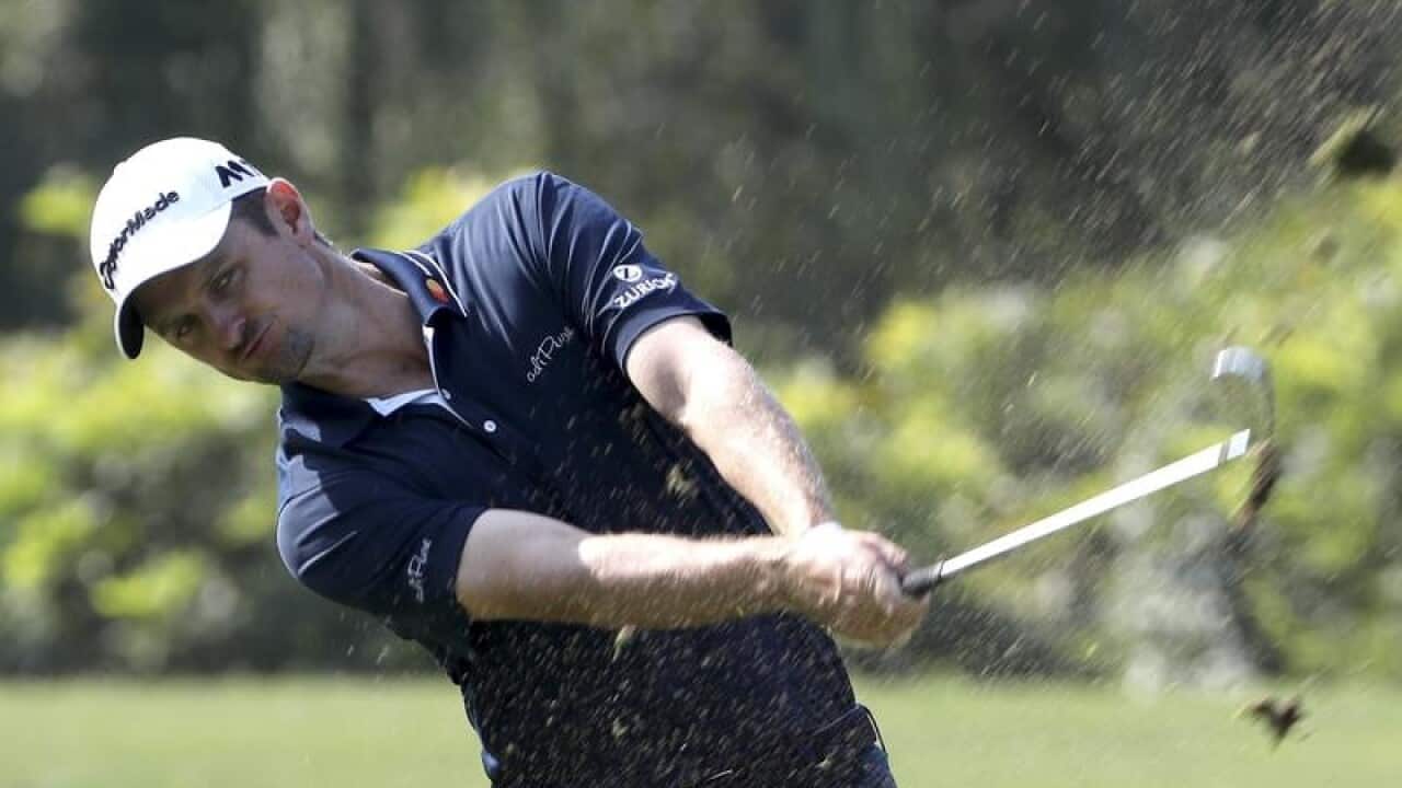 Justin Rose of England hits from the fairway
