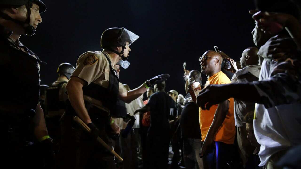 Officers and protesters face off along West Florissant Avenue