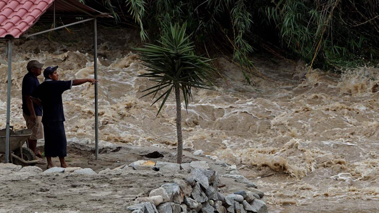 Water overflows the banks of the Santa Eulalia river in Peru