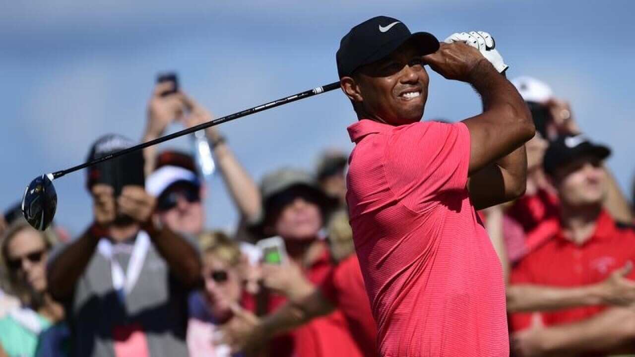 Tiger Woods tees off