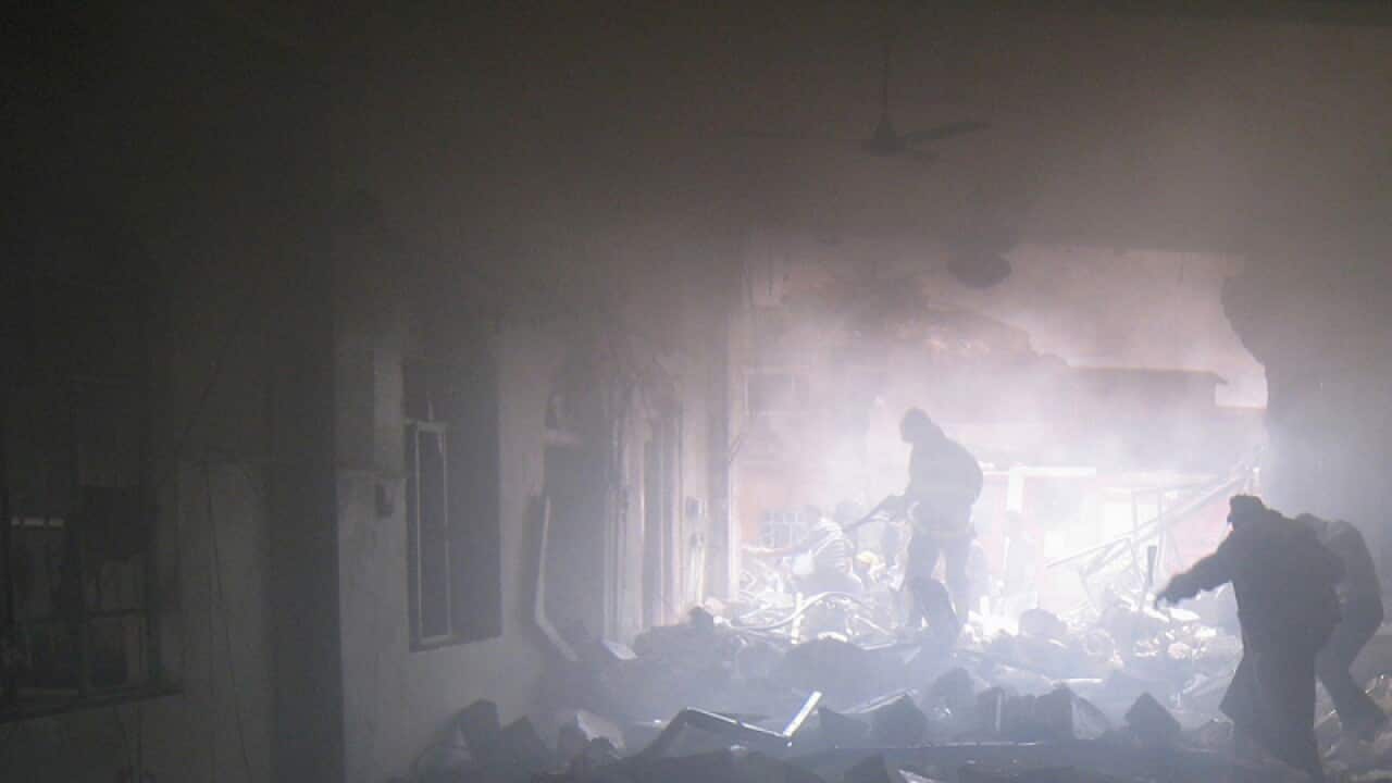 People leave a mosque after a suicide car bomb attack