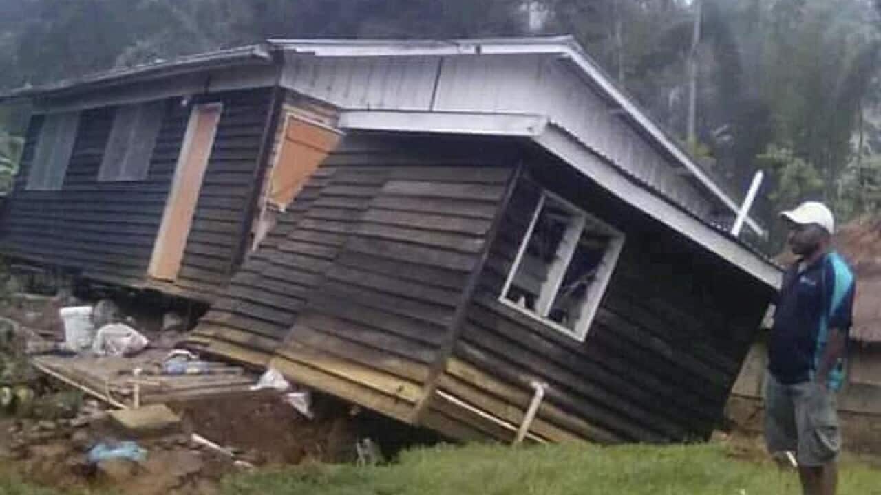 A man views a collapsed house after an earthquake in Papua New Guinea.