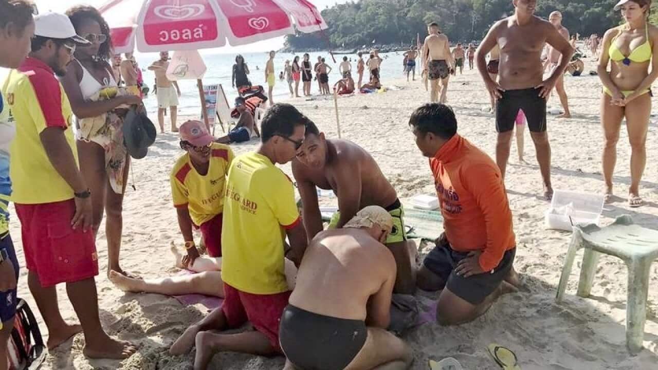 Thai lifeguards giving first aid to rescue a female Australian tourist