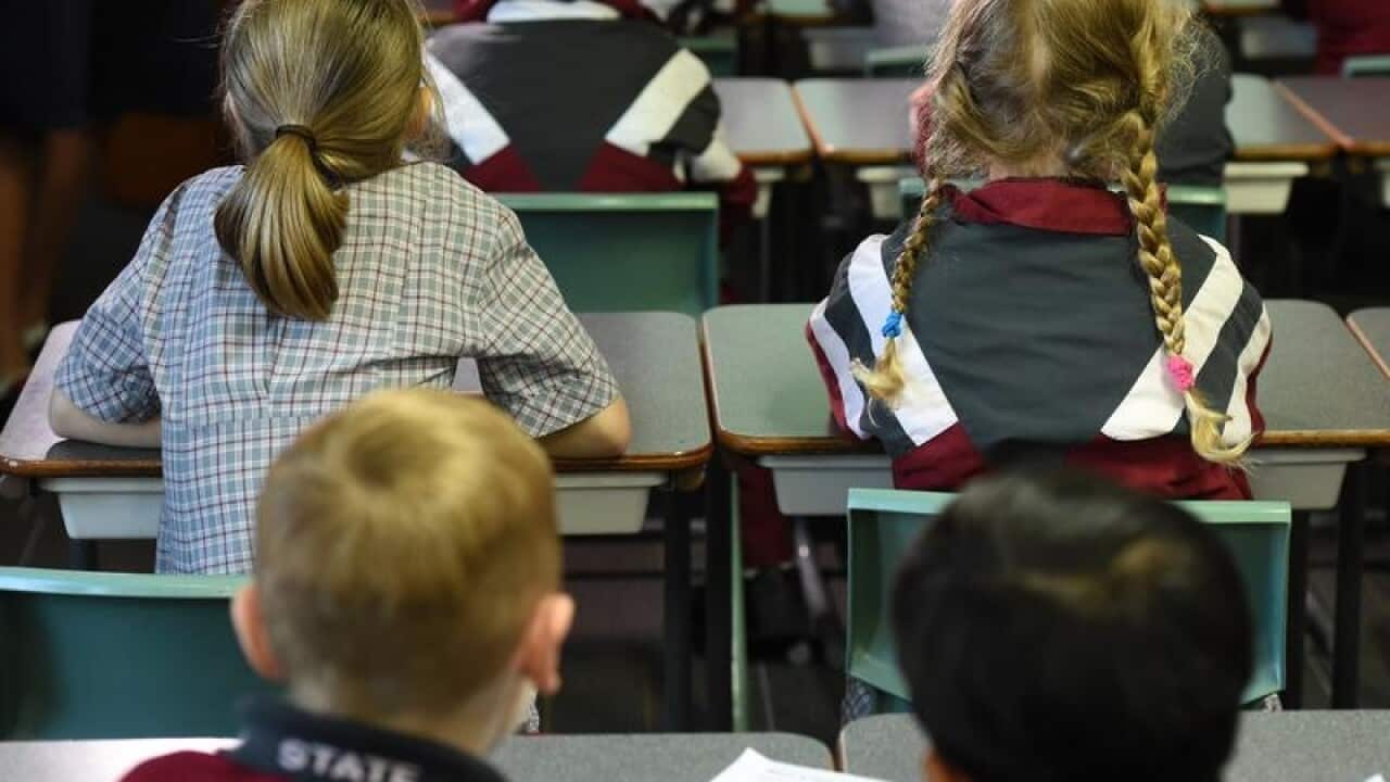 Children sit in a classroom