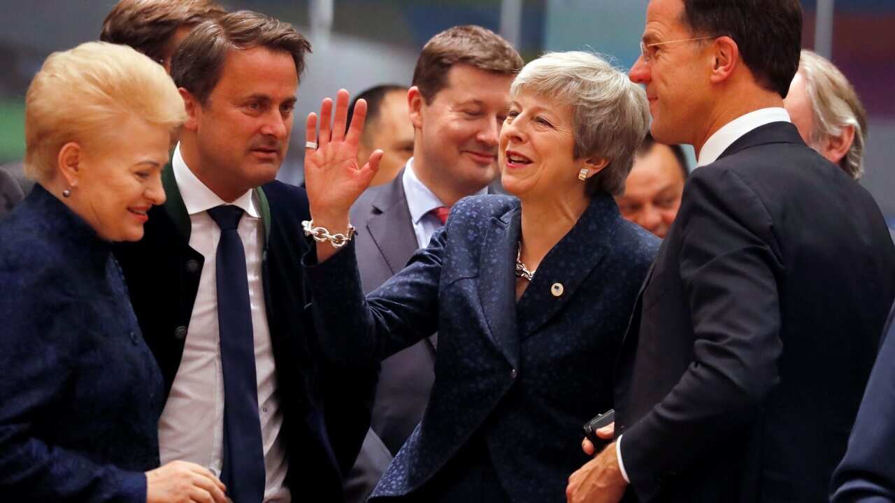 British Prime Minister Theresa May, centre, speaks with Dutch Prime Minister Mark Rutte (right) and Lithuanian President Dalia Grybauskaite (left).