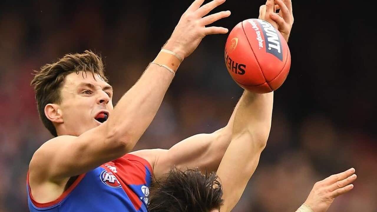 Jake Lever goes up for the ball