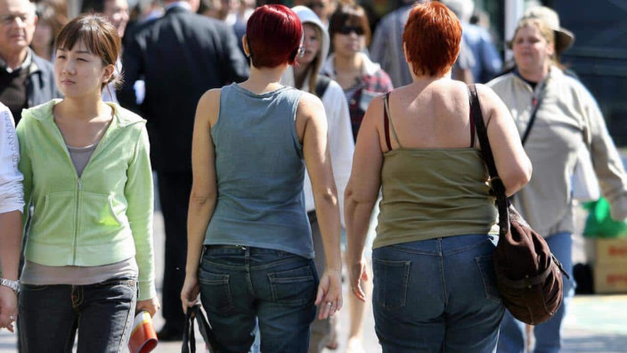 Pedestrians (C) walk through Sydney's Ci