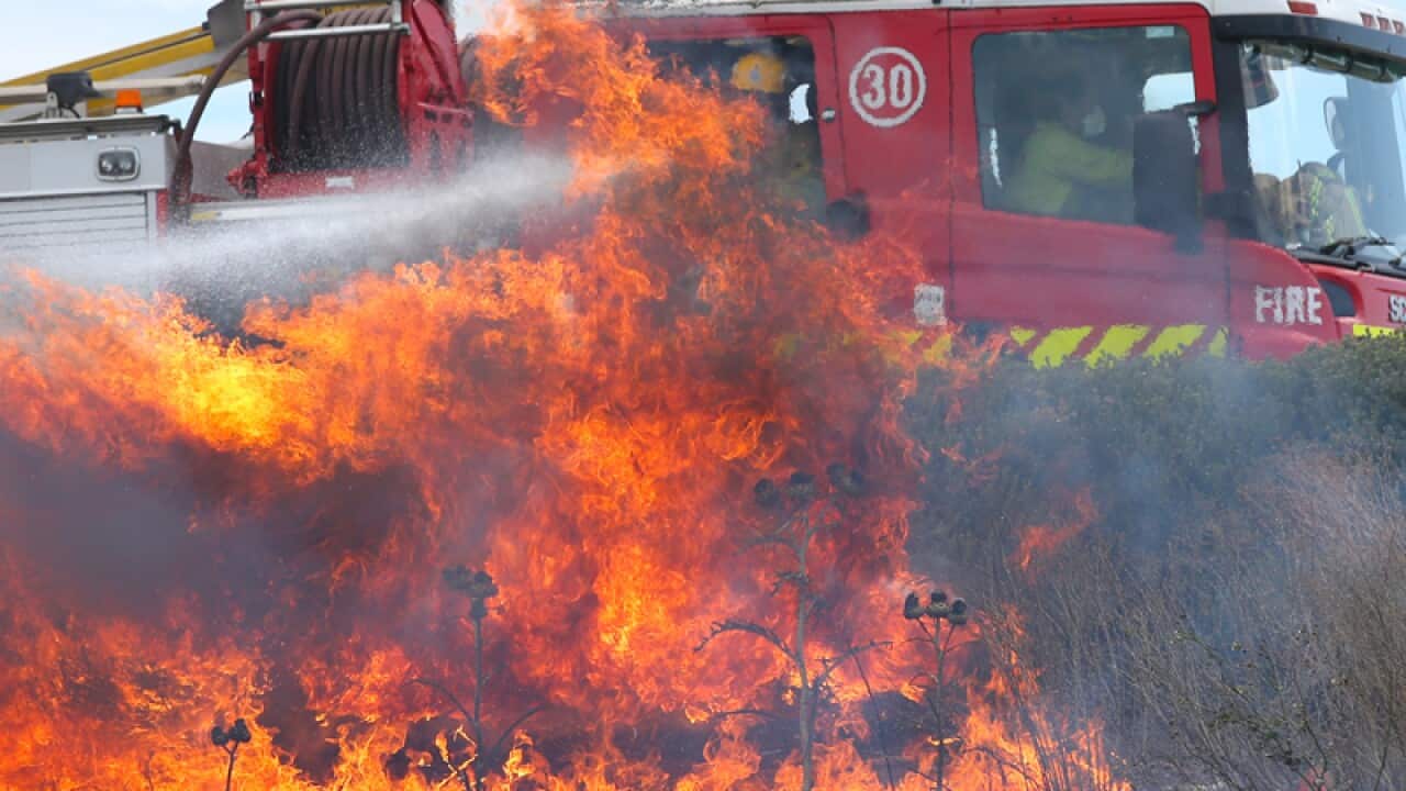 Firefighters at a fast moving grass fire