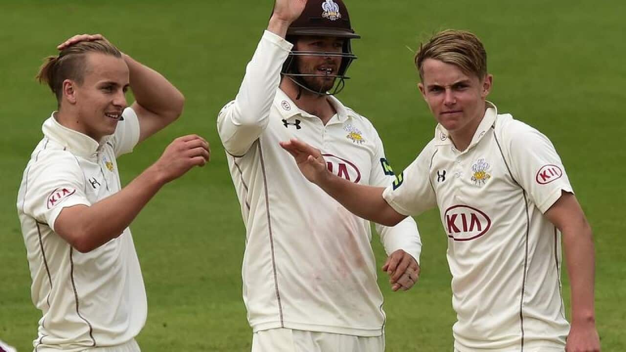 Surrey's Tom Curran (left) congratulates brother Sam (right).
